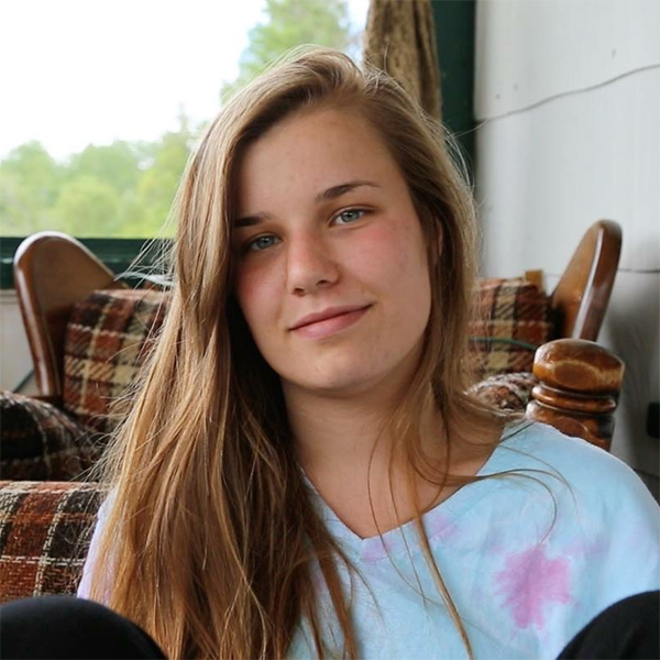 Photo of Claire Mahaffy sitting against a chair.