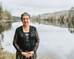 Ellen Musclow, Palmer Rapids, age 72. Ellen stands at the river that winds by her home in Palmer Rapids.
