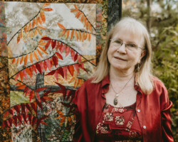 Pat Thurston, Killaloe, age 74. Pat, a local artist, is pictured here with one of her textile creations outside of her home and studio.