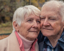 Joan and Robert
Archambault, Barry’s Bay. Ages: Joan 77, Robert 86. Joan and Robert sit together in the backyard of their apartment building in Barry’s Bay.