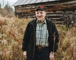 William “Billy” O’Malley, Brudenell, age 74. William standing on his family farm outside of Brudenell.