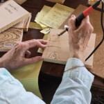 Close up of hands wood burning