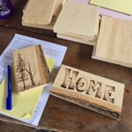 Wood burning pieces sitting on paper