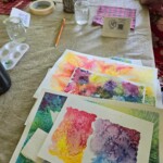 Water colour paintings on a table.