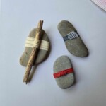 Stones with string and sticks woven across them.