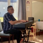 A man plays at an electric keyboard.